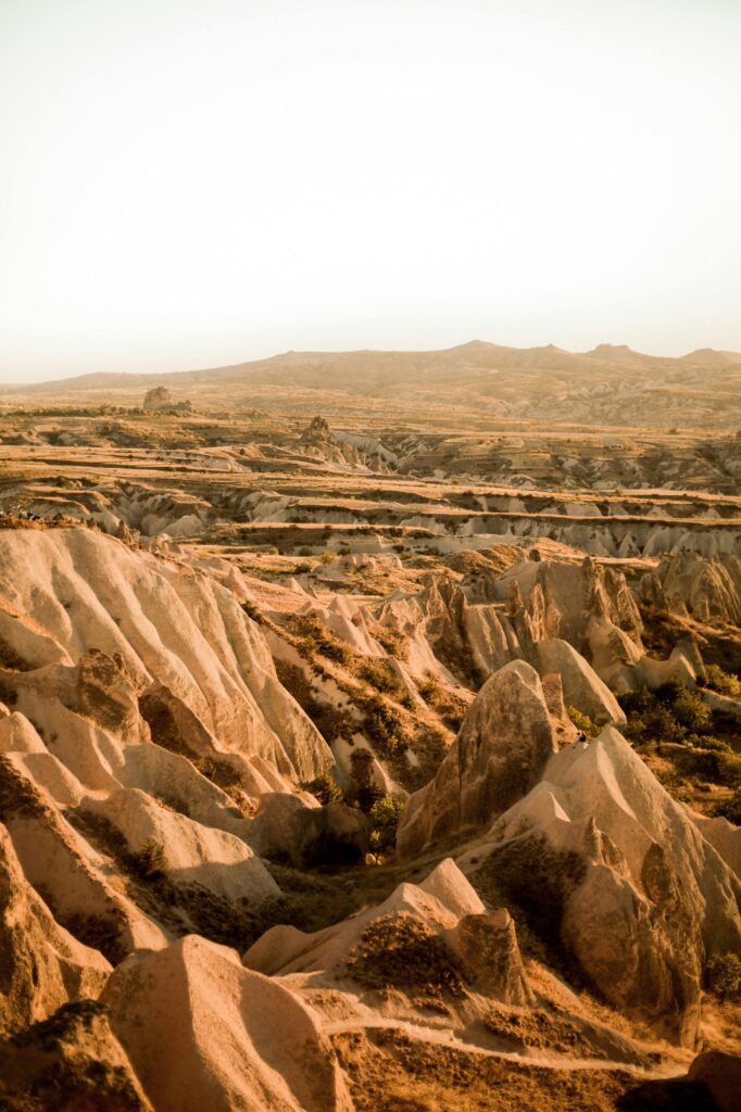 Breathtaking view of Ortahisar's rock formations in Cappadocia, Türkiye, at dusk.