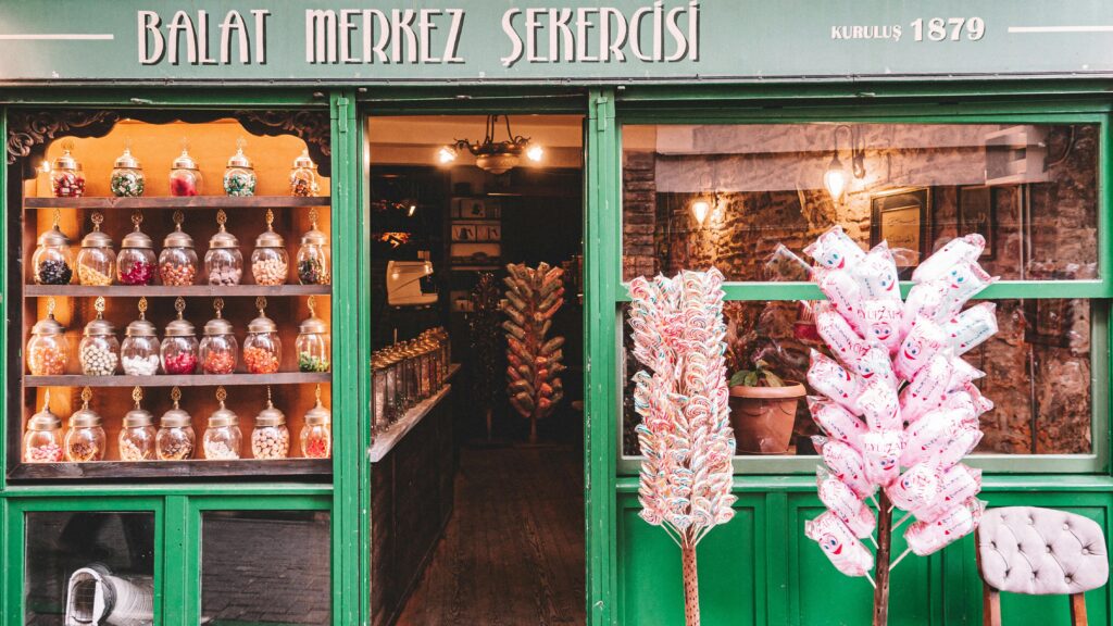 Explore this historic candy shop in Balat, Istanbul, showcasing delightful sweets in a vintage setting.