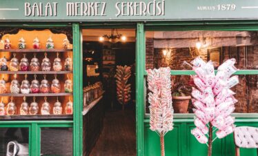 Explore this historic candy shop in Balat, Istanbul, showcasing delightful sweets in a vintage setting.