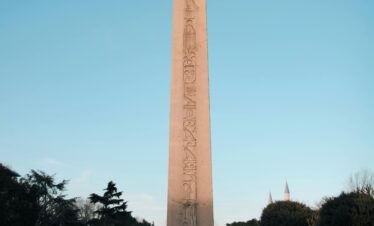 The Obelisk of Theodosius lit by evening light in Istanbul's historic Sultanahmet Square.